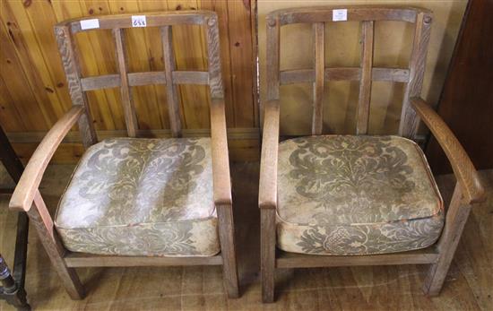 Pair of Arts & Crafts style low oak armchairs, lattice backs, deep loose cushions.